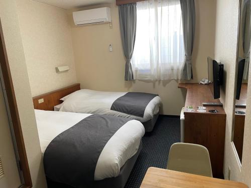 Tempat tidur dalam kamar di Atto Business Hotel Ichinoseki