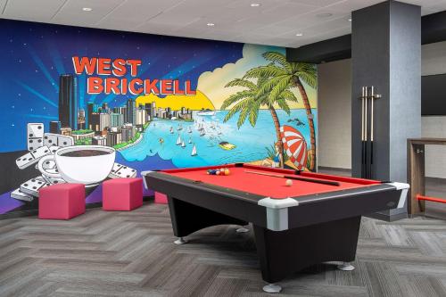 a room with a pool table in front of a mural at Tru By Hilton Miami West Brickell in Miami