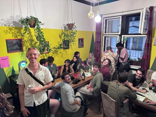 a group of people sitting at tables in a restaurant at Hostel Vagabond in Sarajevo