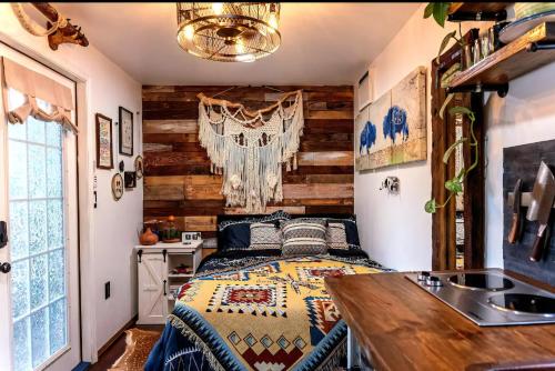 a bedroom with a bed and a wooden wall at Cozy AF Tiny-House Oasis in Tampa