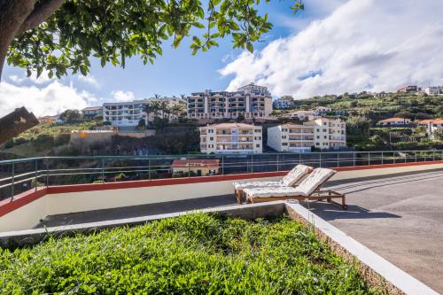 a white couch sitting on the side of a road at Casa Vista Mar by GALMI in Calheta