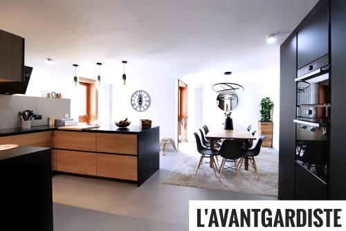 a kitchen and dining room with a table and chairs at L'AvantGardiste, Spacious 6 bedroom panoramic view in Crans-Montana