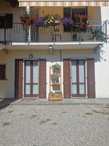 un bâtiment avec des boîtes de fleurs sur un balcon dans l'établissement Lake mood holiday home, à Cadrezzate