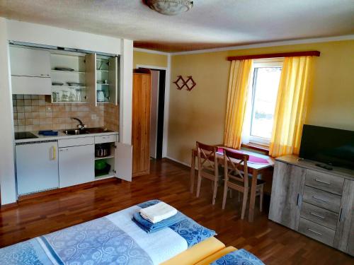 a room with a kitchen and a table with a sink at Hotel Stille in St. Moritz