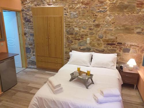 a bedroom with a large bed with towels on it at CityZen Rooms Chios in Chios