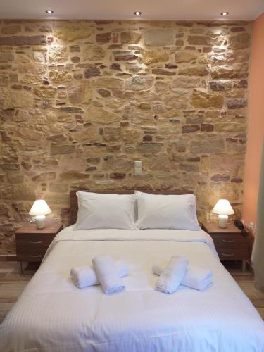 a bedroom with a bed with two pillows on it at CityZen Rooms Chios in Chios