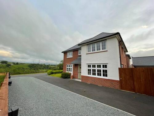 a house on a street with a driveway at Snowdonia Retreat in Bangor