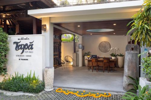 um restaurante com uma sala de jantar com uma mesa em Tapa Tepi Kali Canggu em Canggu