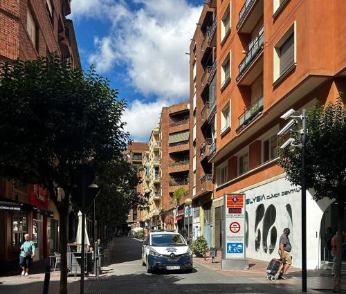 un'auto parcheggiata in una strada di città accanto agli edifici di Gran Via Centro a Logroño