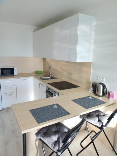 A kitchen or kitchenette at New apartment 5 minutes by walk from the airport with free garage parking