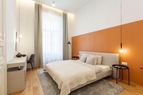 a bedroom with a white bed and a desk at Luxurious Minimalist Residence with Sauna by Prestige Homes in Budapest