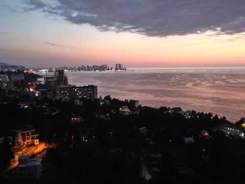 a view of the ocean at sunset at Green Yard Hotel in Batumi