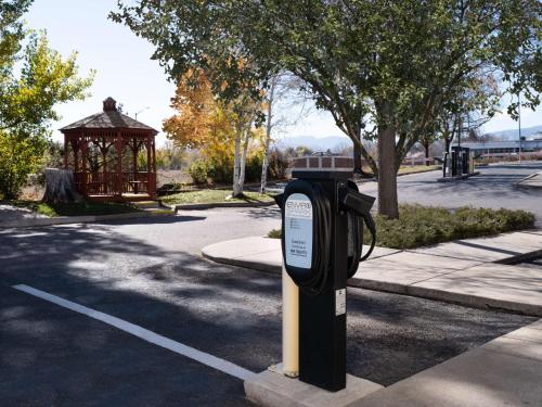 a parking meter in a park with a gazebo at Hilton Fort Collins in Fort Collins