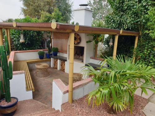 a pergola with a fireplace in a garden at Best Area Close to Leeds Centre in Leeds