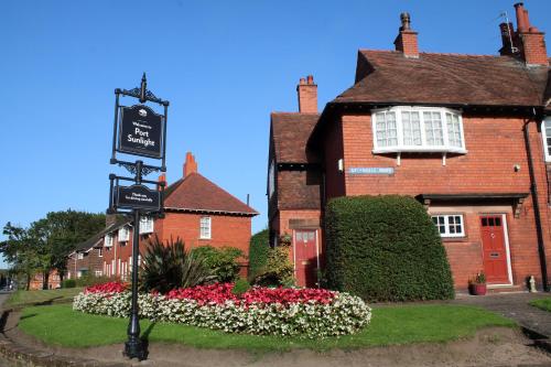 a brick building with a sign in front of it at Charming 1800s Port Sunlight Worker's Cottage in Port Sunlight