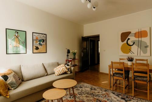 a living room with a couch and a table at Flathouse Apartment 2 Centrum in Białystok