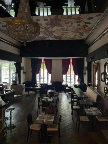 a dining room with tables and chairs and windows at Salon Boyer in Épernay