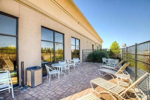 a patio with tables and chairs on a balcony at Hampton Inn & Suites Mountain Home in Mountain Home