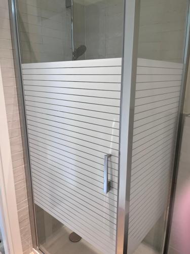 a glass shower door in a bathroom at Monolocale Moderno Valpolicella Verona - Agni in San Pietro in Cariano