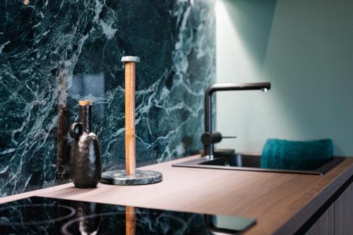 a bathroom counter with a sink and a faucet at Exklusive Design Appartement Palm Paradise Neubau in Pfungstadt