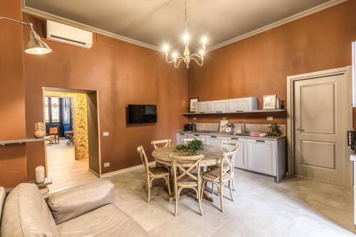 una cucina e una sala da pranzo con tavolo e divano di Corso Miracle Suite a Roma