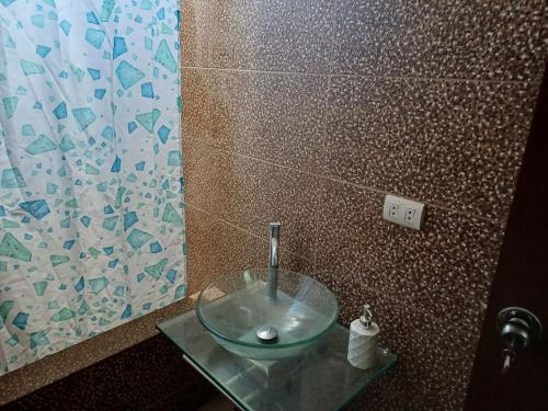 a bathroom with a glass bowl sink on a glass table at DEPARTAMENTO EN YANAHUARA 3er piso in Arequipa