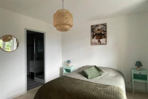 a bedroom with a bed and a pendant light at Gîte NO 9 in Neufchâteau