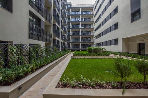 an apartment building with a garden in the middle at K40 Romantic Deluxe Studio In the City Center in Budapest