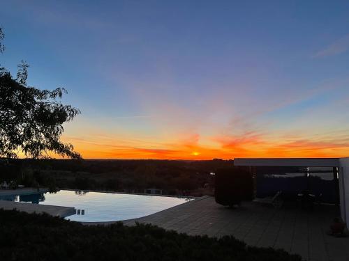 The sunrise or sunset as seen from a vendégházakat or nearby