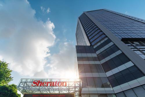 a tall building with a sign in front of it at Sheraton Changsha Hotel in Changsha