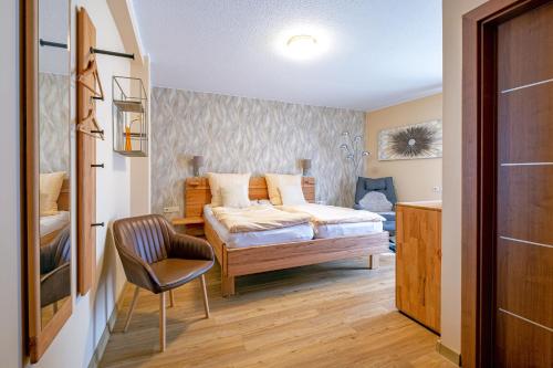 - une chambre avec un lit et une chaise dans l'établissement Alt Wehlheiden, à Cassel