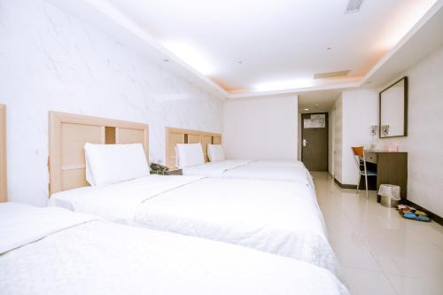 Tempat tidur dalam kamar di Guide Hotel Taoyuan Fuxing