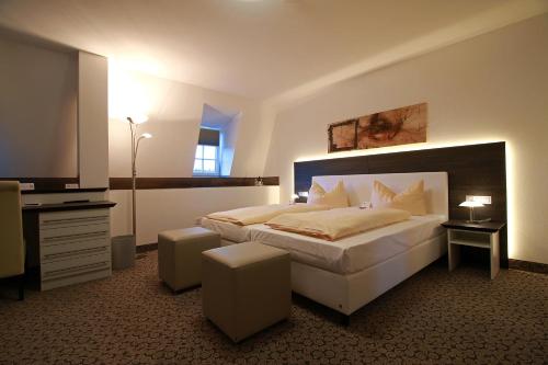 A bed or beds in a room at Schlosshotel Weilburg