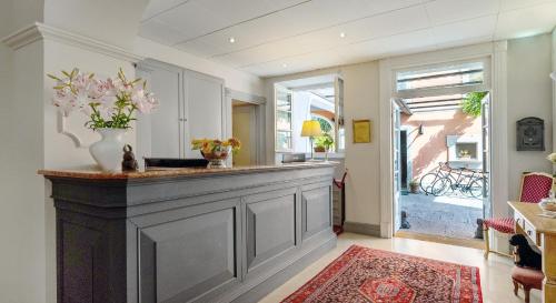 a kitchen with a counter with a vase of flowers at Residenza dei Fiori in Cannero Riviera