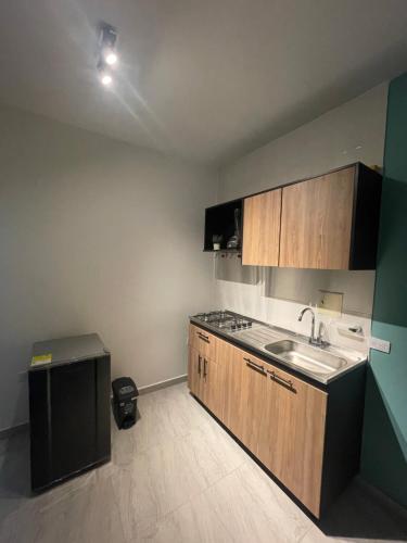 an empty kitchen with a sink and a counter at Bonito Apartamento Monteria in Montería