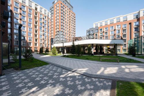 a courtyard in a city with tall buildings at Апартаменты бизнес-класса в ЖК 4YOU in Almaty