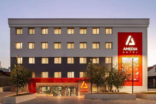 a large building with aania sign in front of it at Amedia Milan, Trademark Collection by Wyndham in Milan