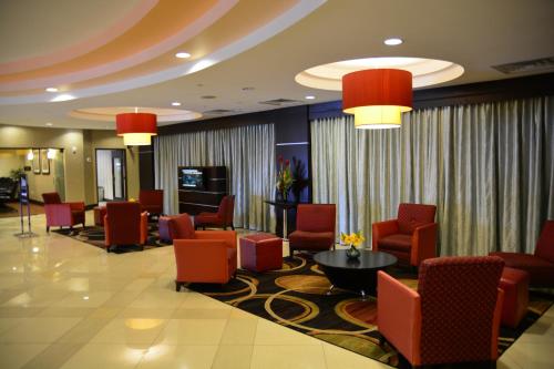 a waiting room with chairs and a table in a hotel at Lux Hotel & Spa, Trademark Collection by Wyndham in Arlington