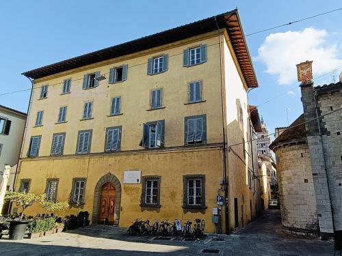 een geel gebouw met buiten geparkeerde fietsen bij Appartamenti Forteguerriana in Pistoia