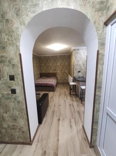 a bedroom with a bed and a table in a room at gabro in Mtskheta