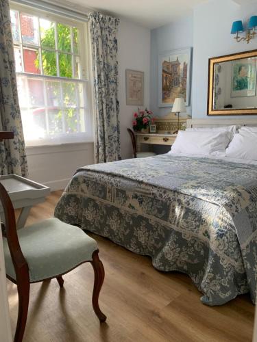 - une chambre avec un lit, une chaise et une fenêtre dans l'établissement Esme's, à Winchester