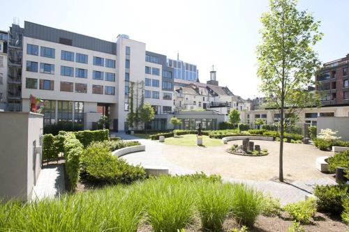 a courtyard in front of a building with buildings at Hostel Van Gogh in Brussels