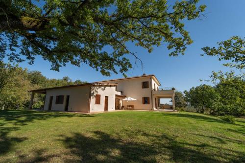 una grande casa bianca con un ampio cortile di Poggio delle Ginestre a Orvieto