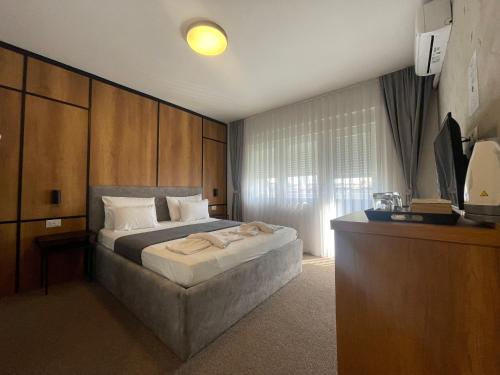 A bed or beds in a room at New Prishtina Luxury Rooms