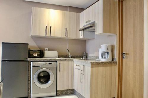 een keuken met een wasmachine en een wasmachine bij Atlas-Résidence by Rent-Inn in Rabat