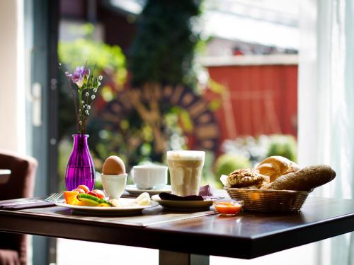 a table with breakfast foods and coffee on it at Pension Stadthalle in Vienna