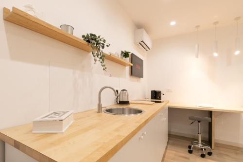 a kitchen with a sink and a counter at Maison Nona in Torre del Greco