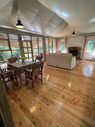 een grote woonkamer met een tafel en een bank bij Olesamara Collection in Nanyuki