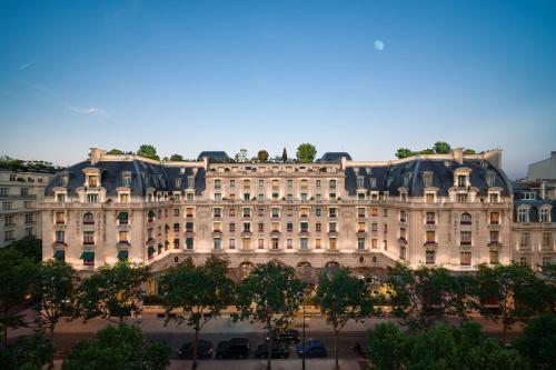 a large building with trees in front of it at The Peninsula Paris in Paris