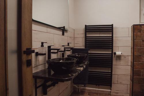 a bathroom with three bowls on a counter at IQ Apartments in Prešov